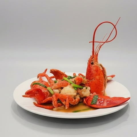 lobster dish on a white plate with other dishes in the background