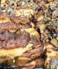 Close-up of braised pork belly with a dark background